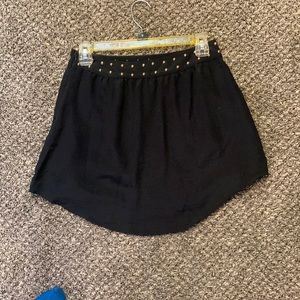 Black mini skirt with gold beaded waist detail. SIZE S.
